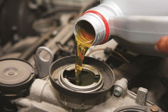 Pour oil into Suzuki Engine